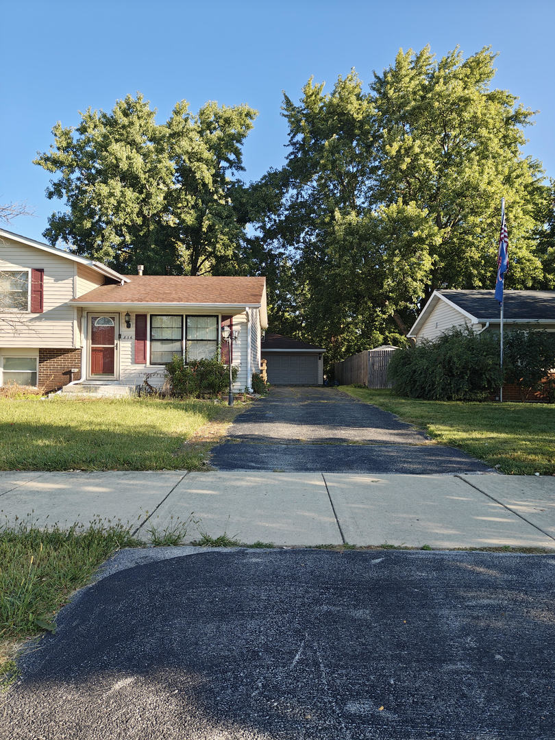 836 Lily Cache Lane Bolingbrook, IL 60440 - Photo 3 of 3 a view of a house with a big yard and large trees