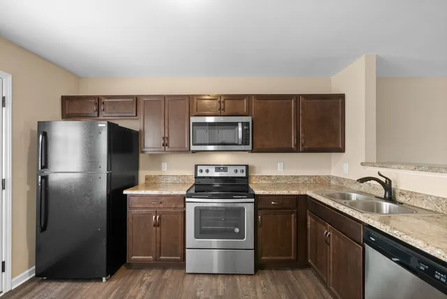 a kitchen with a sink stove and refrigerator