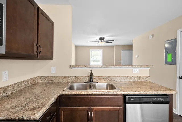 a kitchen with granite countertop a sink and cabinets