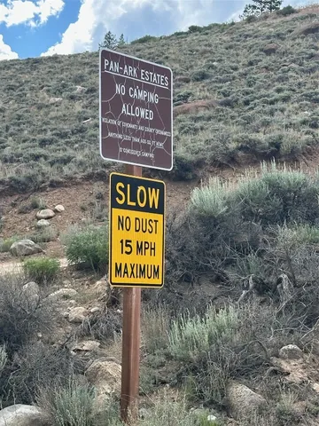 a view of a dry yard with mountains in the background