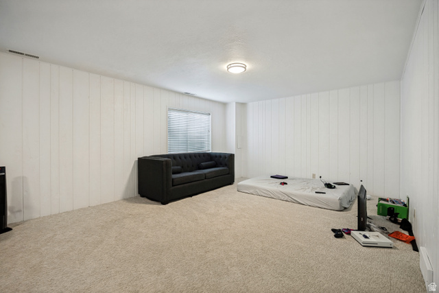 6709 Acoma Road, Unit 239 Midvale, UT 84047 - Photo 15 of 38 6711 - Basement Living Room. White paneling walls, neutral tone carpet, recessed lighting, and a single window with blinds