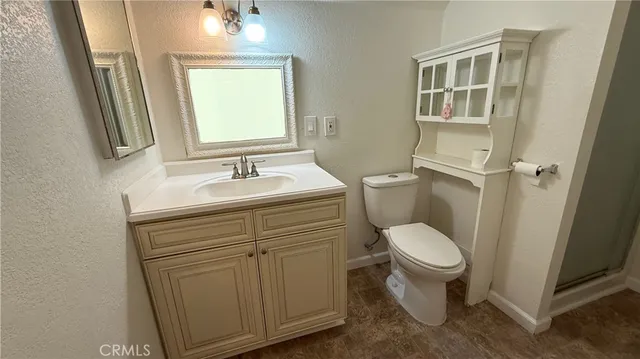 a bathroom with a sink toilet and mirror