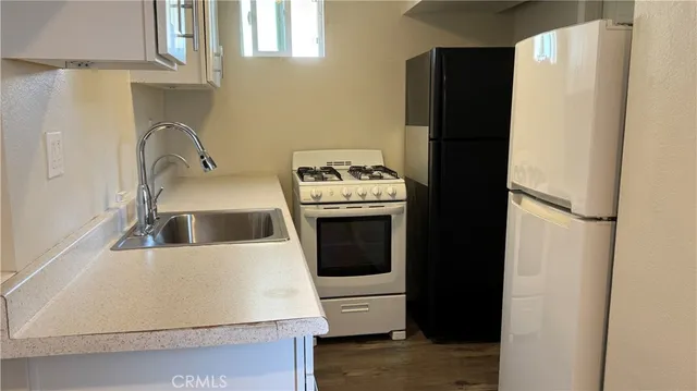 a kitchen with a stove and a refrigerator
