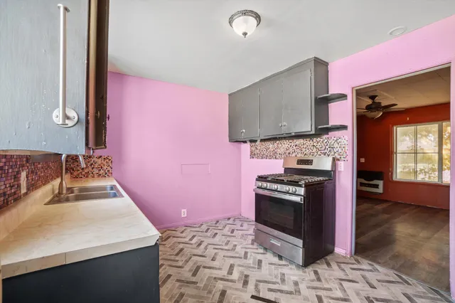 a kitchen with a stove a sink and a microwave