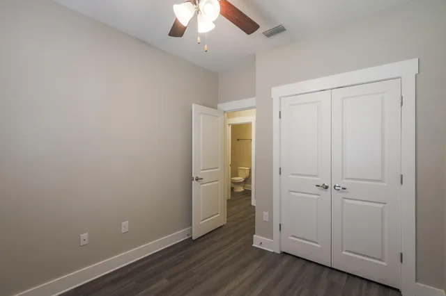 an empty room with wooden floor and cabinet