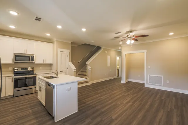 a kitchen with a sink and steel appliances