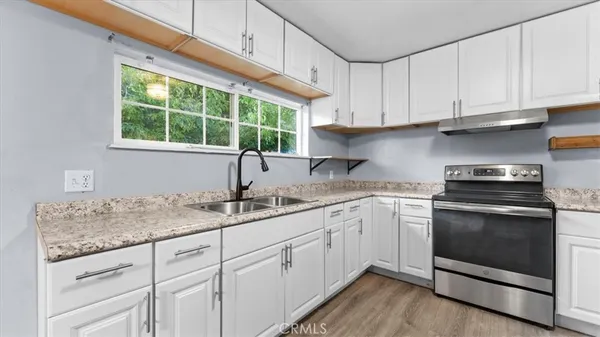 a kitchen with appliances cabinets and a sink