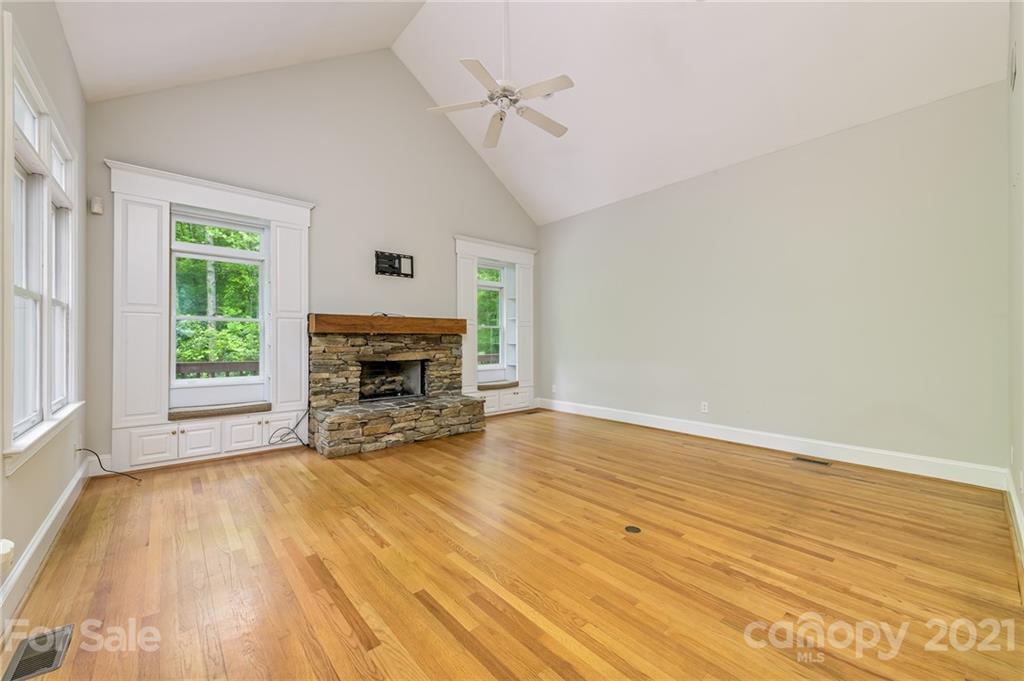 712 Lochaven Road Waxhaw, NC 28173 - Photo 12 of 38 a view of empty room with wooden floor and fireplace