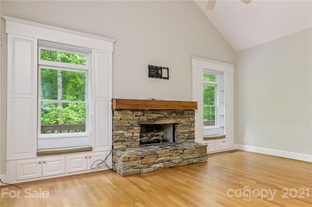 712 Lochaven Road Waxhaw, NC 28173 - Photo 13 of 38 a living room with a fireplace and a wooden floor