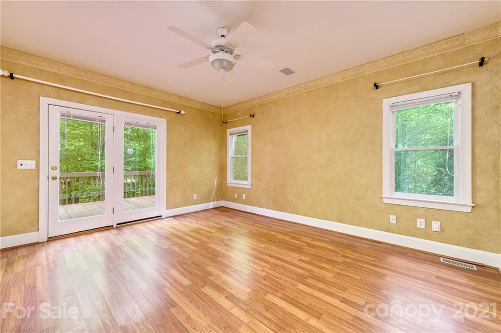 712 Lochaven Road Waxhaw, NC 28173 - Photo 15 of 38 a view of an empty room with wooden floor and a window