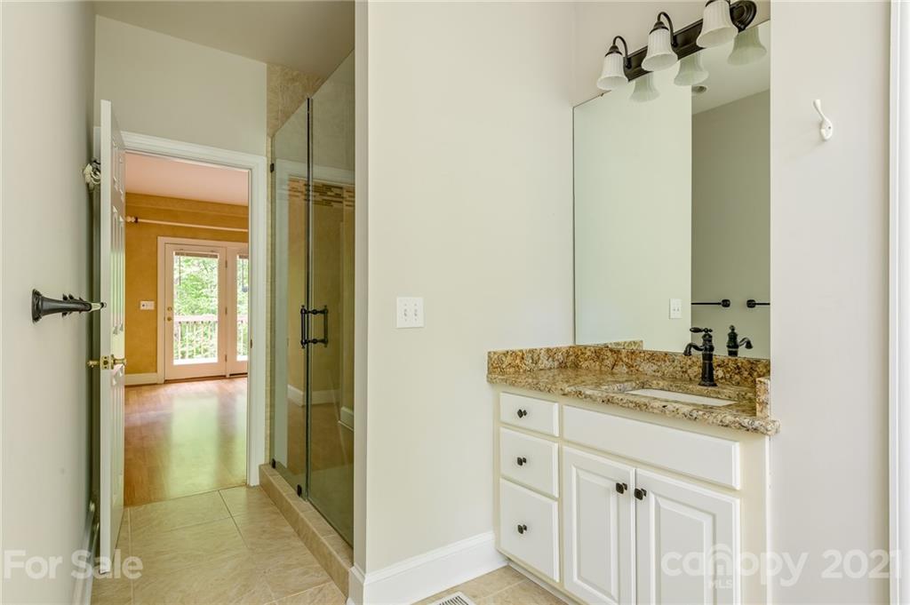 712 Lochaven Road Waxhaw, NC 28173 - Photo 17 of 38 a bathroom with a granite countertop sink and a mirror