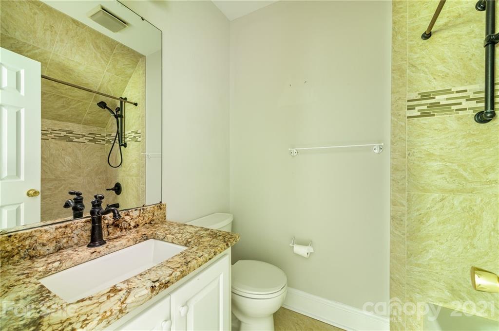 712 Lochaven Road Waxhaw, NC 28173 - Photo 22 of 38 a bathroom with a granite countertop sink toilet and shower