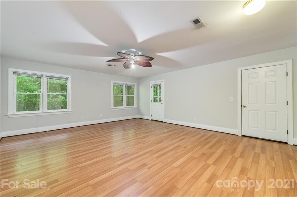 712 Lochaven Road Waxhaw, NC 28173 - Photo 24 of 38 a view of an empty room with wooden floor and a window