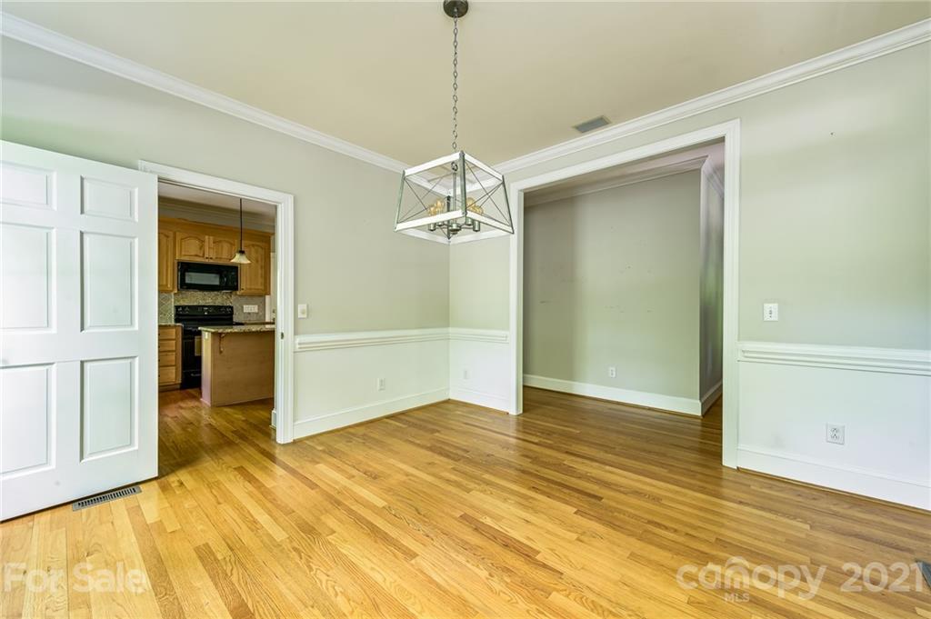 712 Lochaven Road Waxhaw, NC 28173 - Photo 8 of 38 a view of a kitchen with wooden floor and a ceiling fan