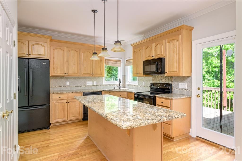 712 Lochaven Road Waxhaw, NC 28173 - Photo 9 of 38 a kitchen with stainless steel appliances granite countertop a refrigerator stove and sink