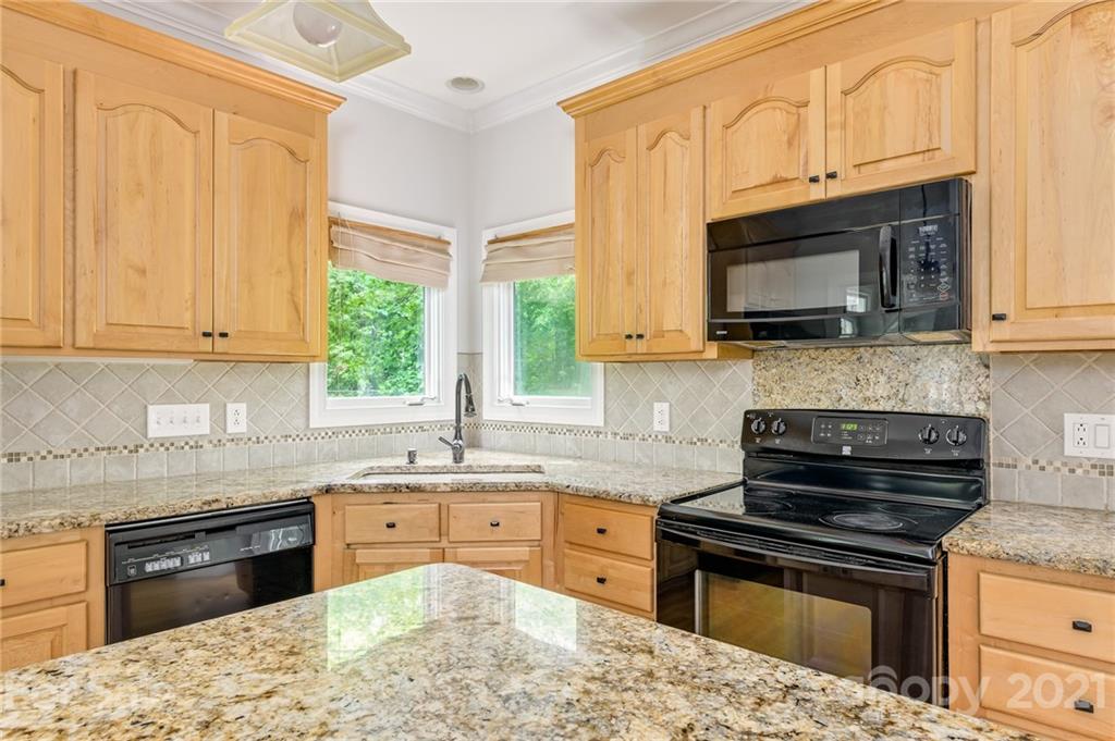 712 Lochaven Road Waxhaw, NC 28173 - Photo 10 of 38 a kitchen with stainless steel appliances granite countertop a stove sink microwave and cabinets