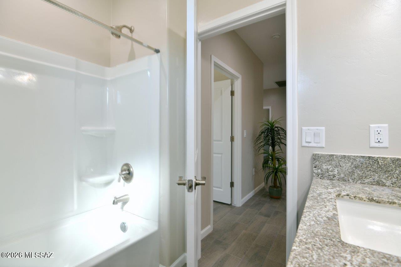 1091 North Vail View Road Vail, AZ 85641 - Photo 29 of 43 a bathroom with a granite countertop tub sink and mirror