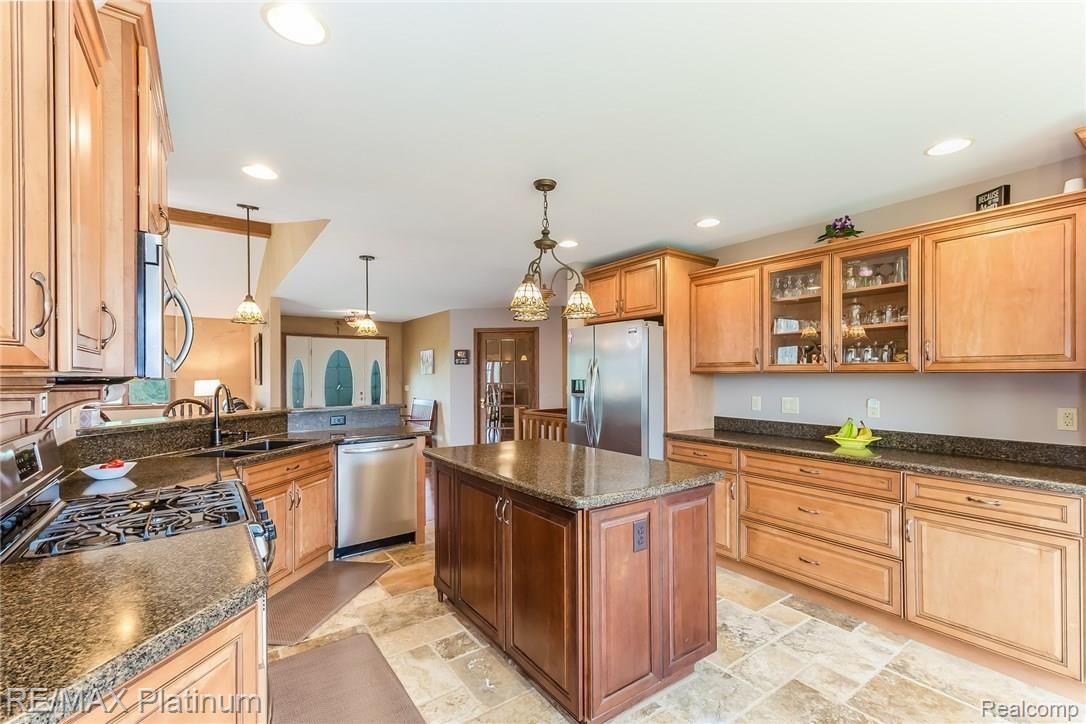 4558 North Latson Road Howell, MI 48855 - Photo 10 of 46 Spacious Island Kitchen with Custom Cabinetry and Corian C'tops