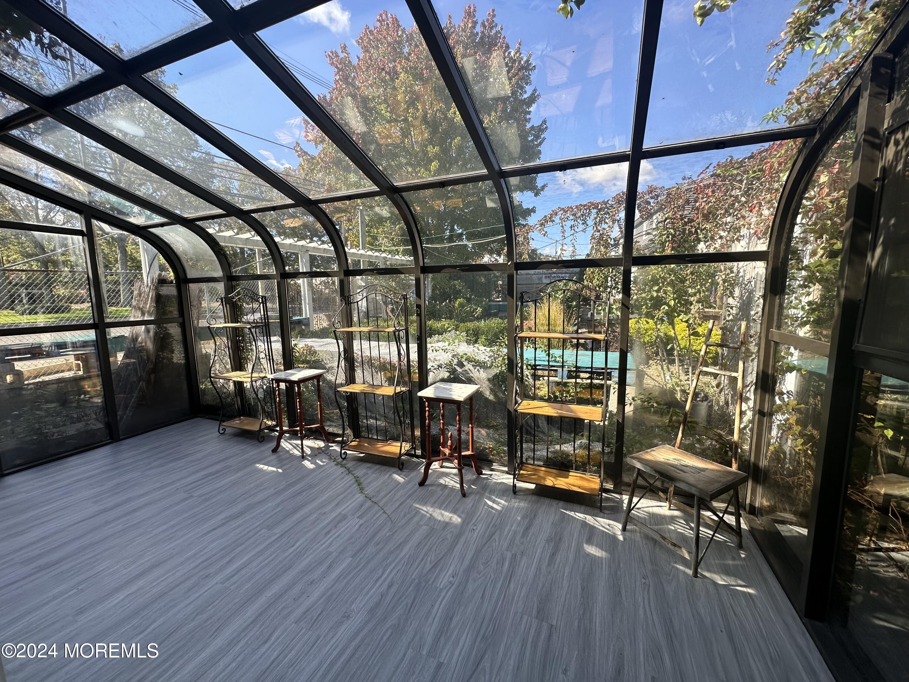 570 Mantoloking Road Brick, NJ 08723 - Photo 7 of 23 a living room with furniture and a floor to ceiling window