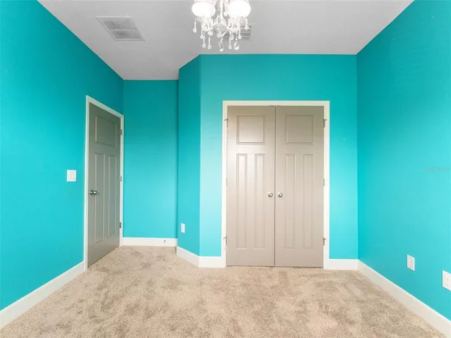 a view of a hallway with a yellow closet