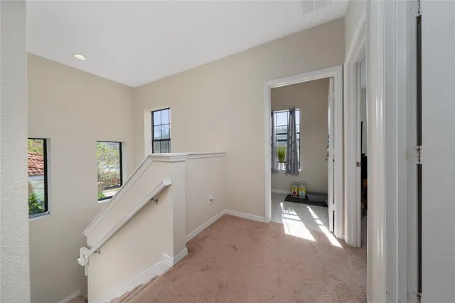 a view of a hallway with a livingroom and a bathroom