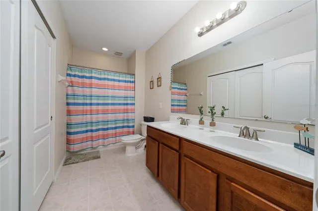 a bathroom with a sink a large mirror and a shower