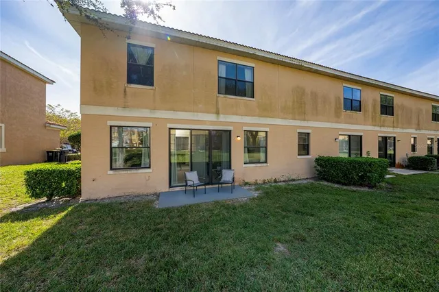a front view of a house with a yard and outdoor seating