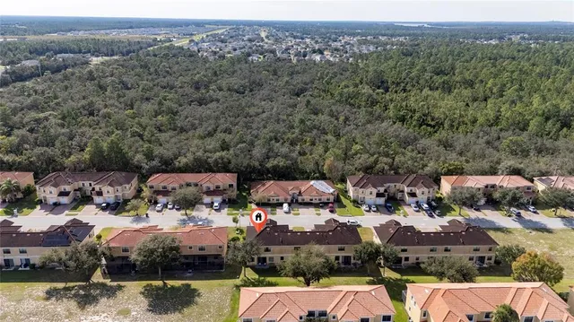 a view of a town with mountains & house