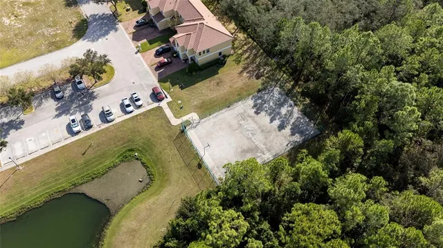 an aerial view of a house with a yard and lake view
