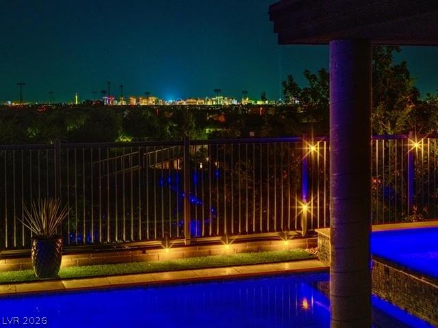 6014 Willow Ridge Court Las Vegas, NV 89135 - Photo 97 of 99 An illuminated backyard pool with panoramic city views provides an idyllic evening retreat.
