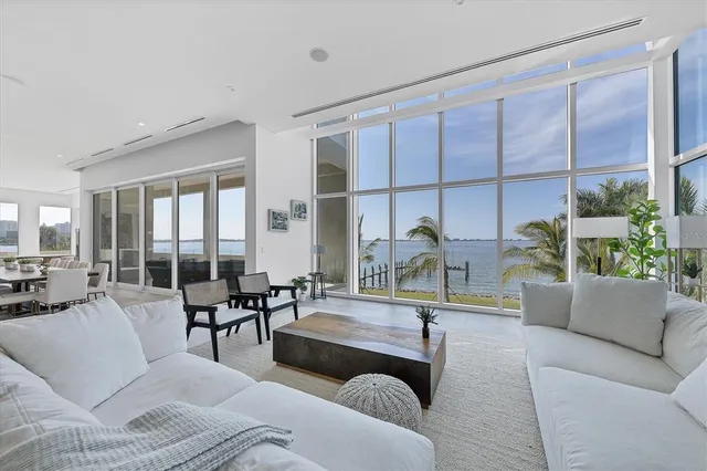 a living room with furniture and a dining table with kitchen view