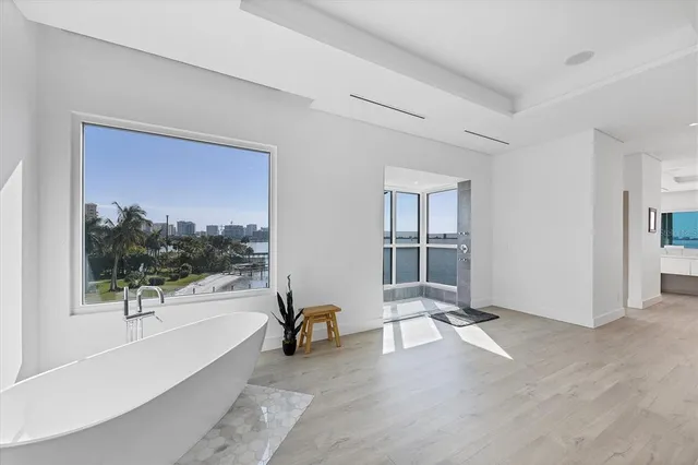 a view of a room that has a large window and front door