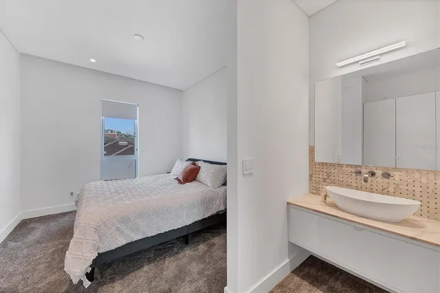 a spacious bedroom with a bed and couch