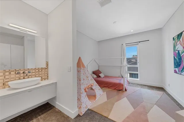 a front view of multi story residential apartment building with yard and green space