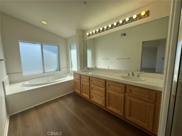 a bathroom with a double vanity sink and a mirror