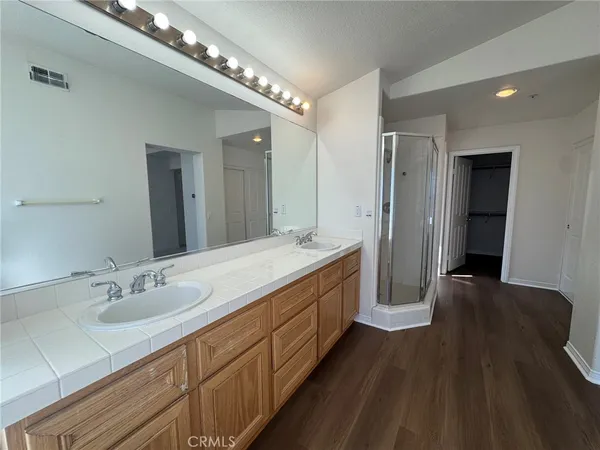 a spacious bathroom with a double vanity sink and a mirror