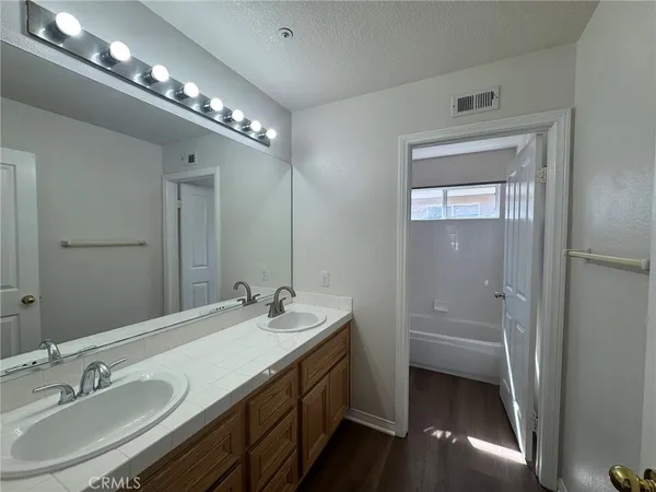 a bathroom with a double vanity sink and a mirror
