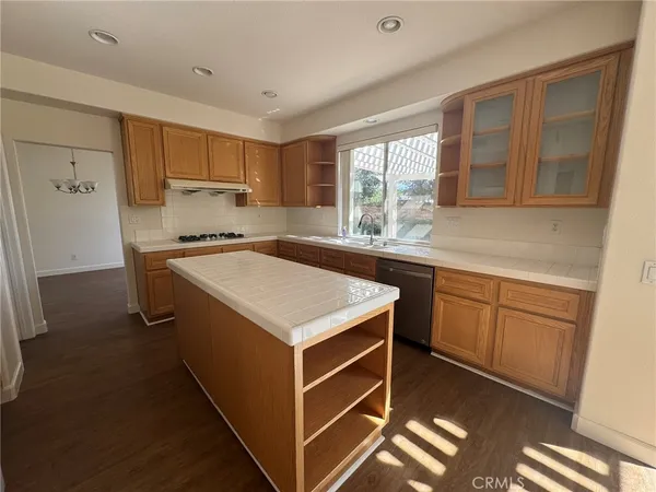 a kitchen with a stove a sink and a refrigerator