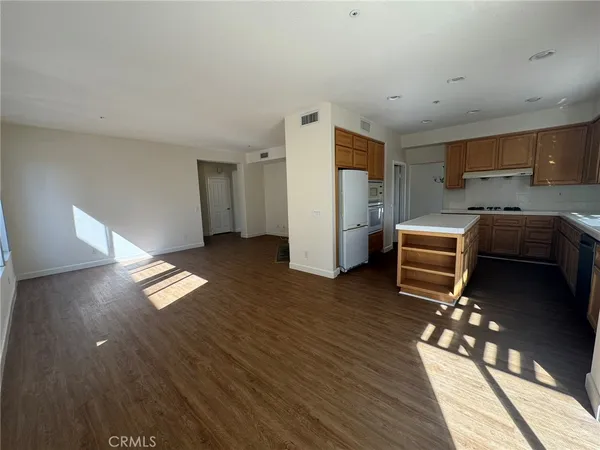 a kitchen with stainless steel appliances a refrigerator and a stove top oven
