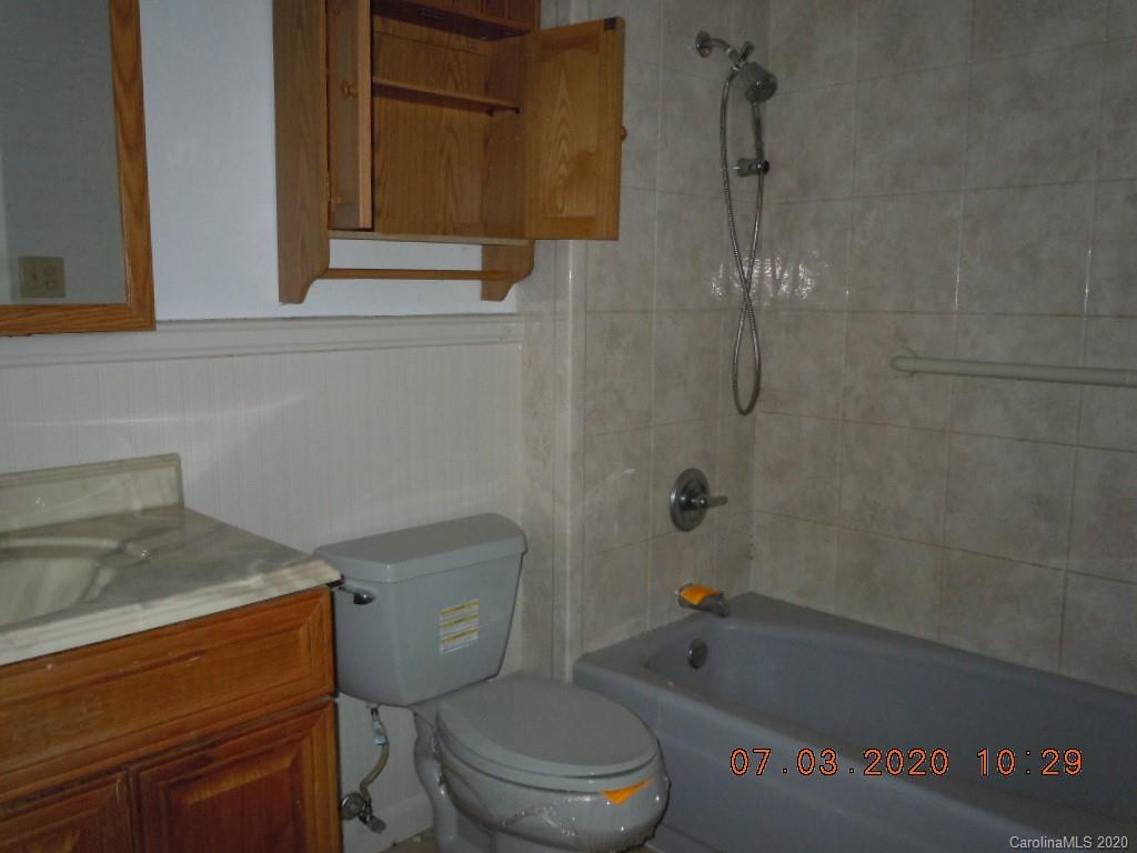 26 Thompson Cove Road Clyde, NC 28721 - Photo 14 of 16 a bathroom with a toilet and a shower