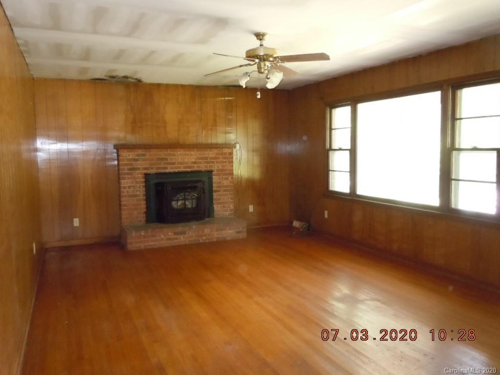 26 Thompson Cove Road Clyde, NC 28721 - Photo 7 of 16 wooden floor fireplace and windows in an empty room