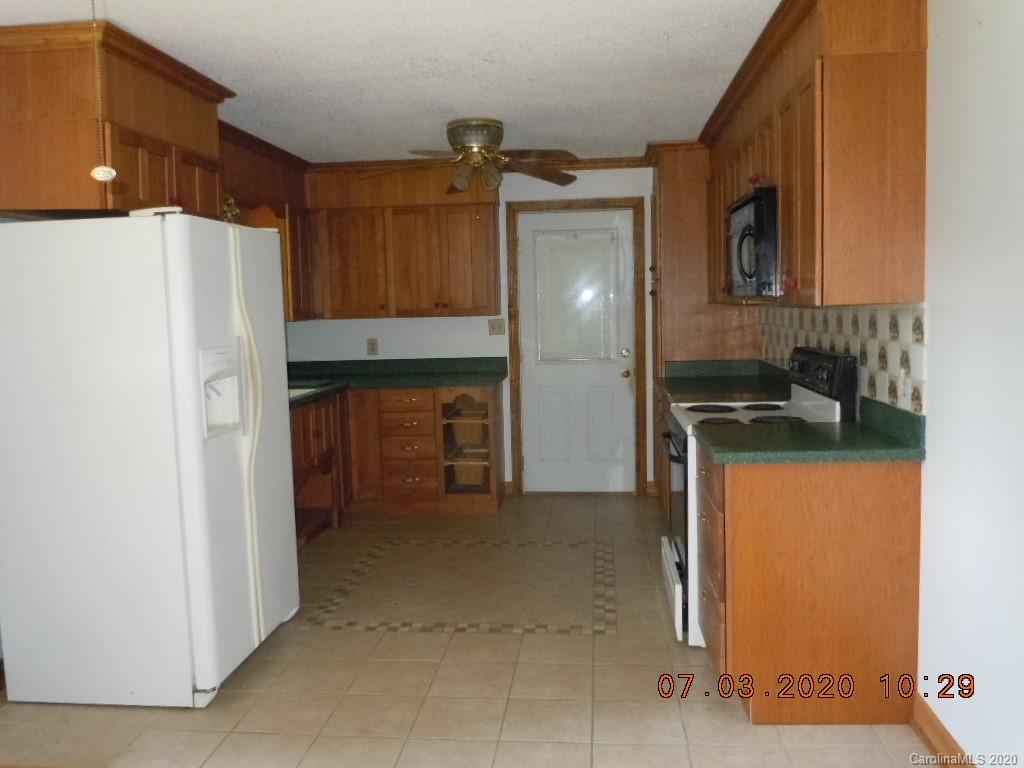 26 Thompson Cove Road Clyde, NC 28721 - Photo 8 of 16 a kitchen with a refrigerator and a sink