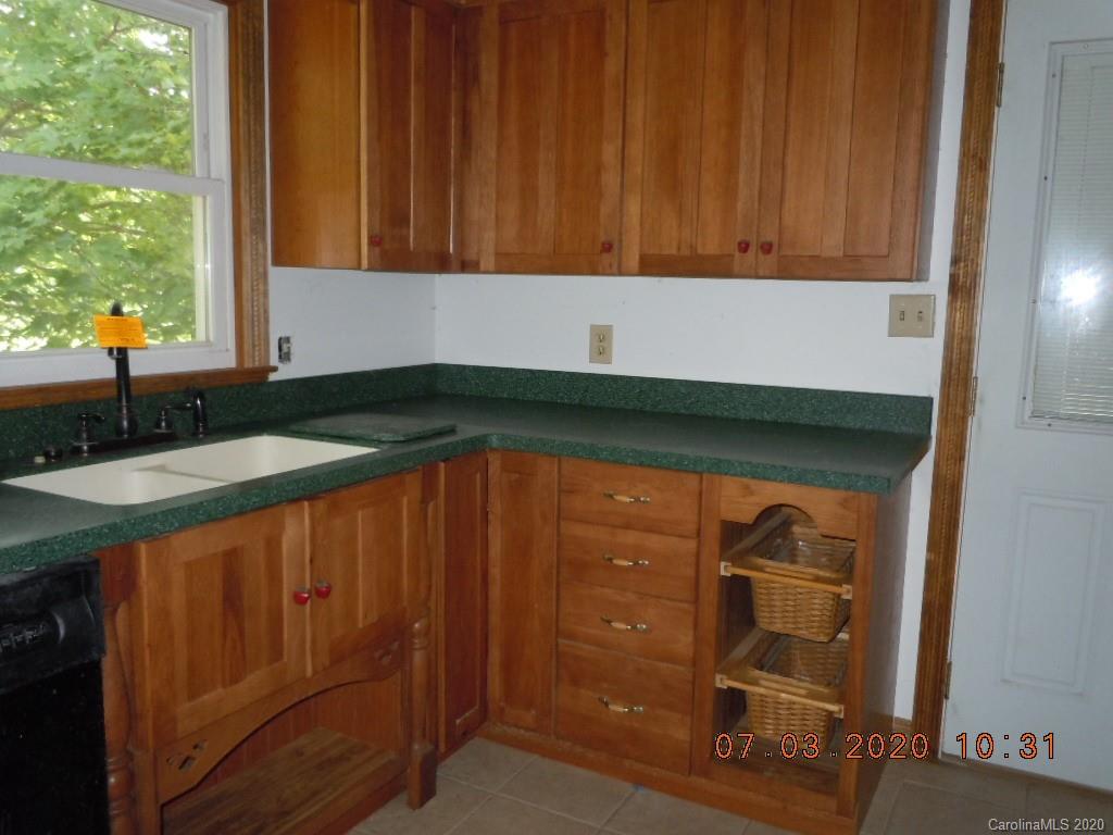 26 Thompson Cove Road Clyde, NC 28721 - Photo 9 of 16 a kitchen with a sink and cabinets