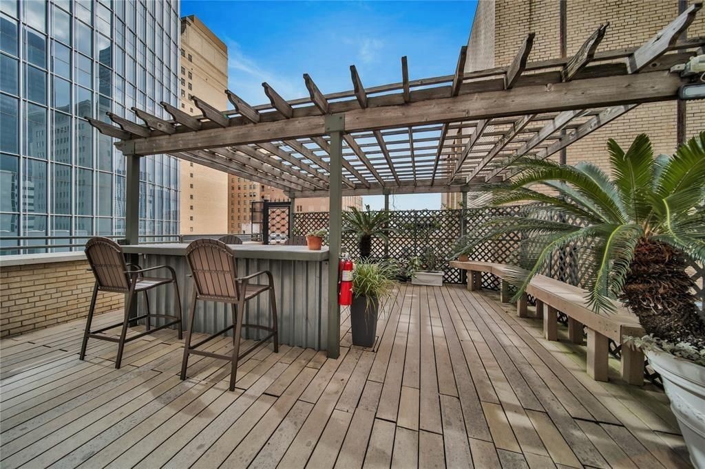 705 Main Street, Unit 610 Houston, TX 77002 - Photo 10 of 15 a view of a chairs and table on the wooden floor