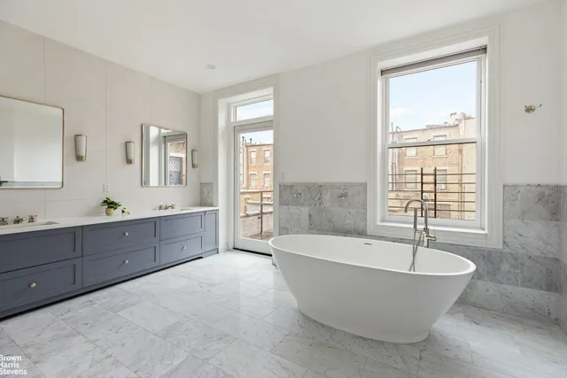 a bedroom with a bed couch and window