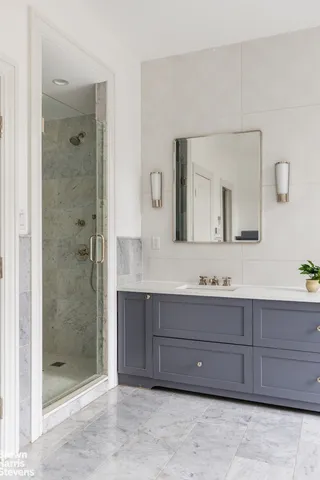 a spacious bathroom with a tub sink and mirror