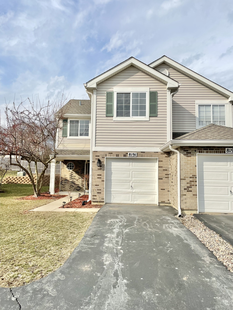 8191 Ripple Ridge Darien, IL 60561 - Photo 1 of 20 a front view of a house with a yard