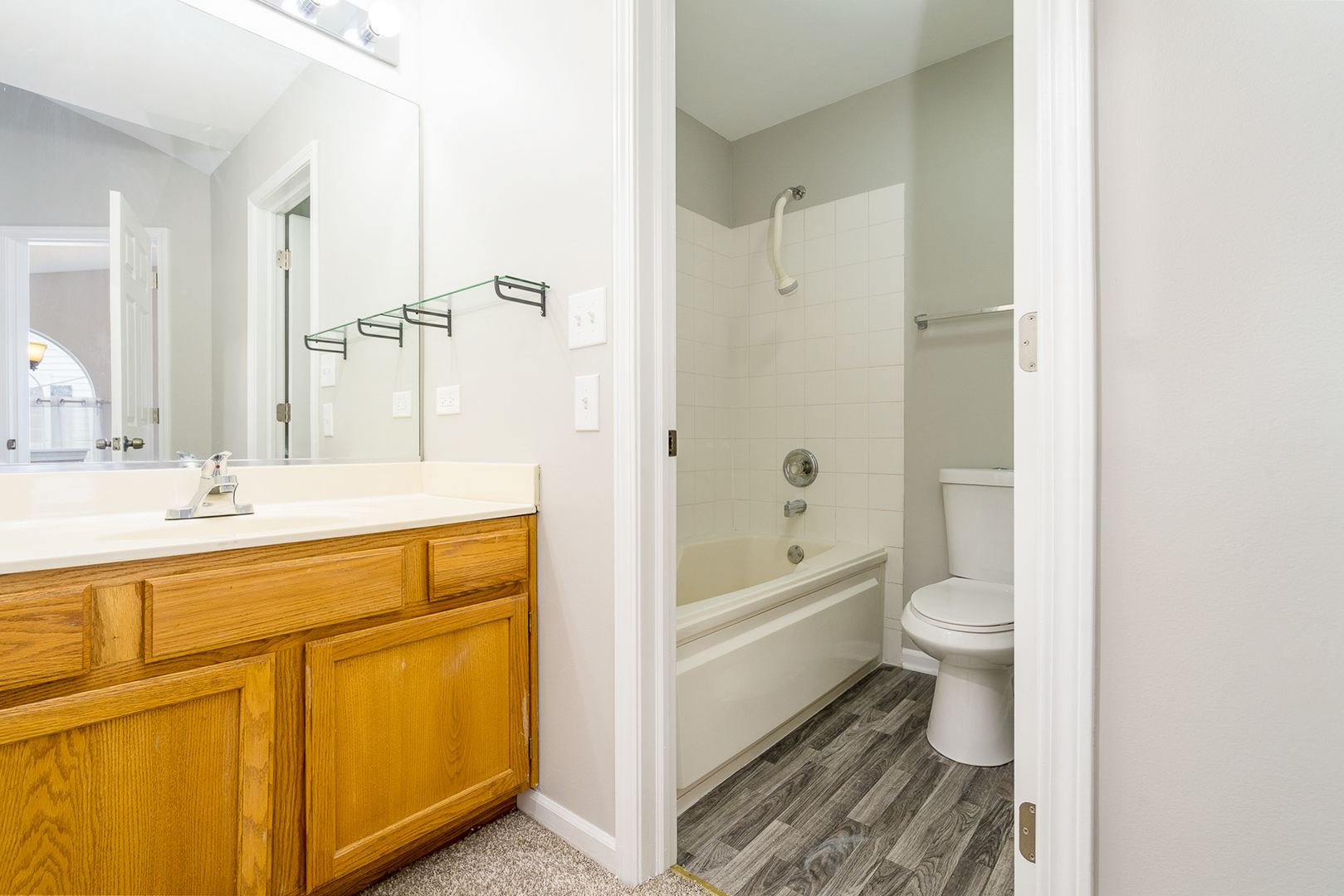8191 Ripple Ridge Darien, IL 60561 - Photo 12 of 20 a bathroom with a granite countertop toilet a sink and bathtub