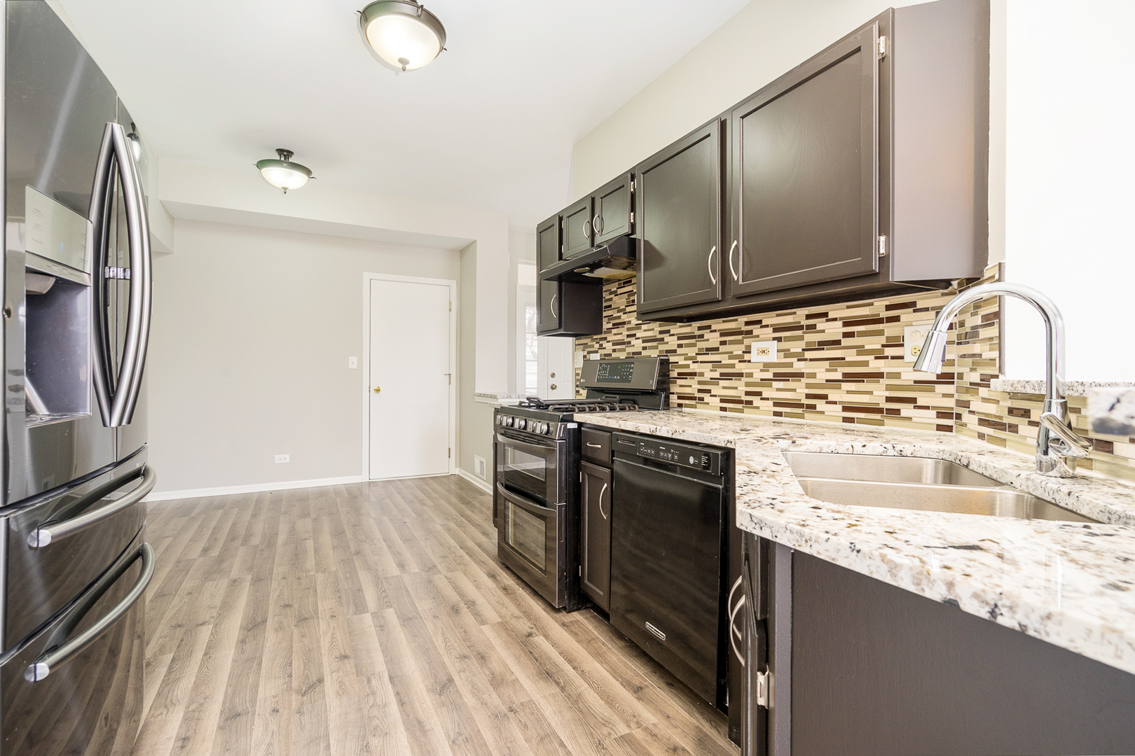 8191 Ripple Ridge Darien, IL 60561 - Photo 3 of 20 a kitchen with granite countertop a sink stove and refrigerator
