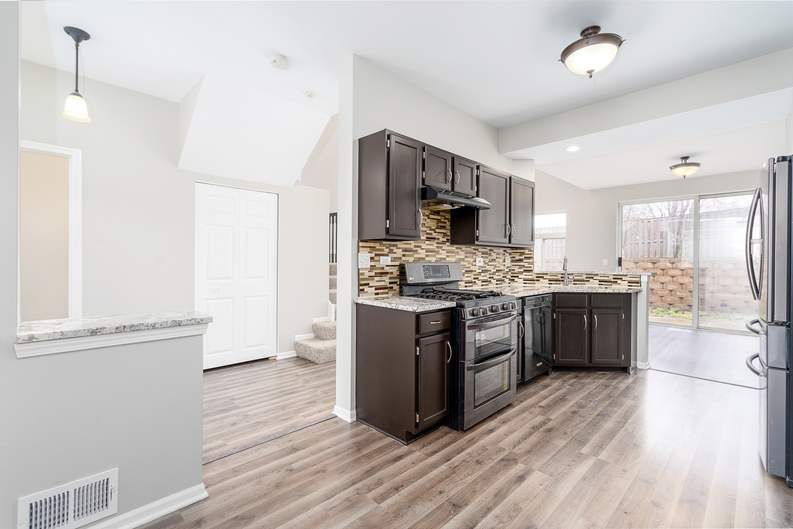 8191 Ripple Ridge Darien, IL 60561 - Photo 4 of 20 a large kitchen with a center island and stainless steel appliances